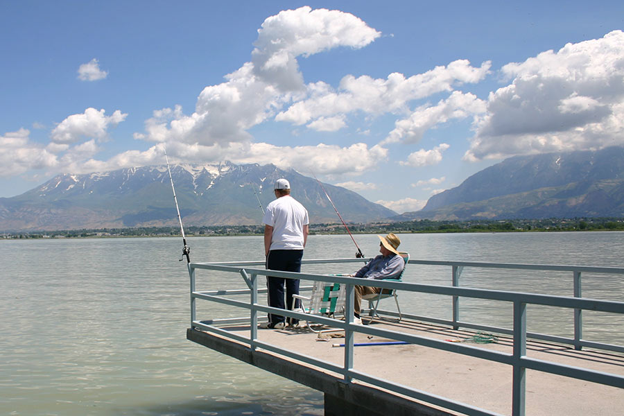 Two anglers fishing from a pier at Utah Lake