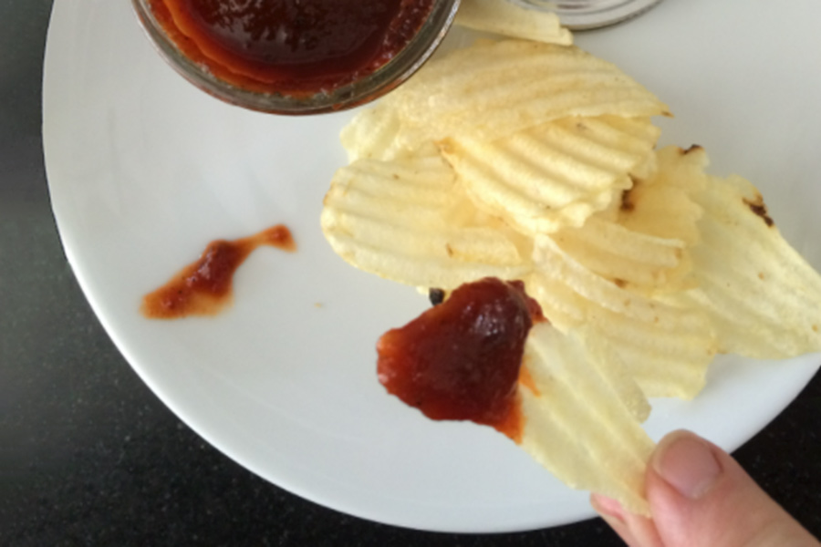 Dipping chips in charred pepper sauce