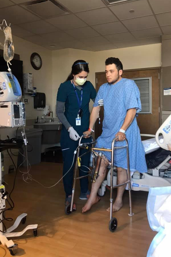 Coy Kummer in his hospital room, standing on his leg