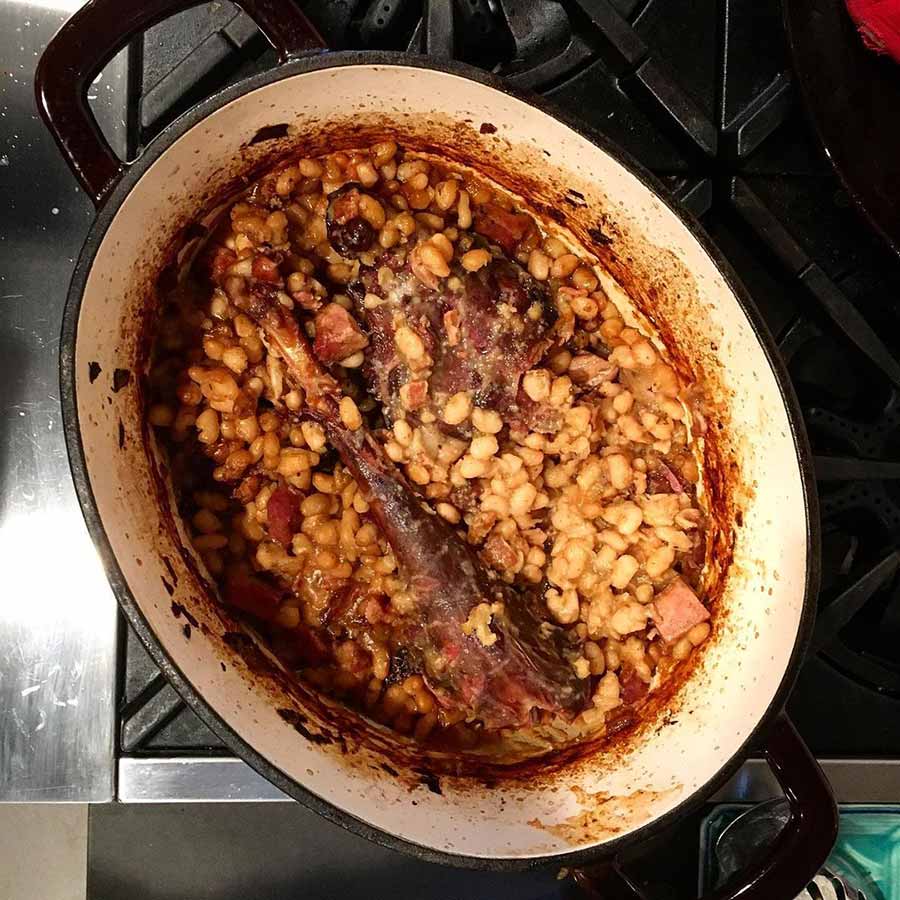 Wild turkey cassoulet in a Dutch oven on a stove