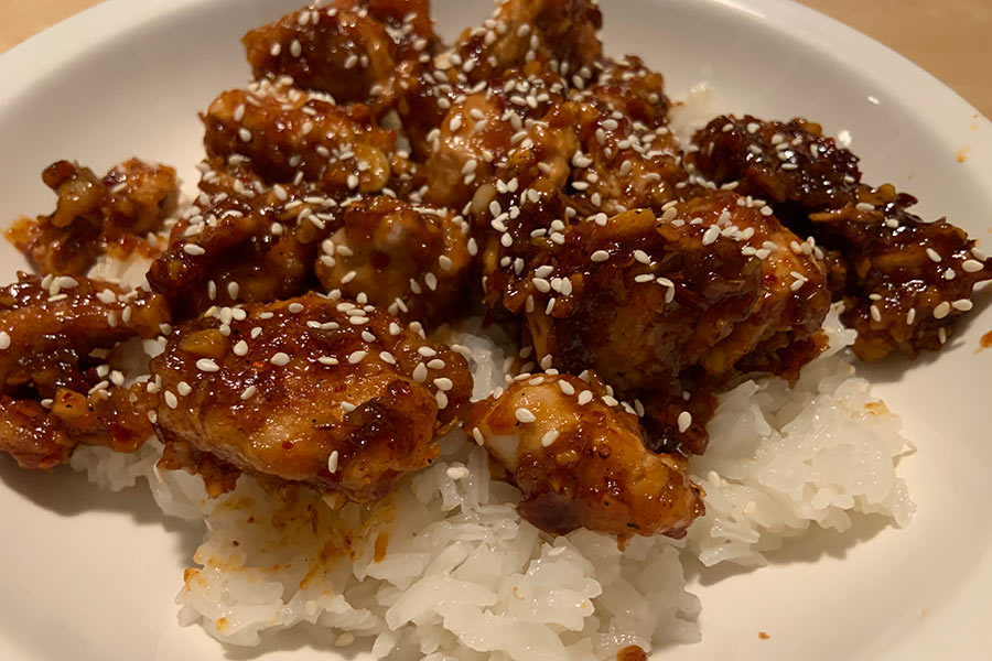 Plate of cooked General Tso's chukar with sesame seeds and rice