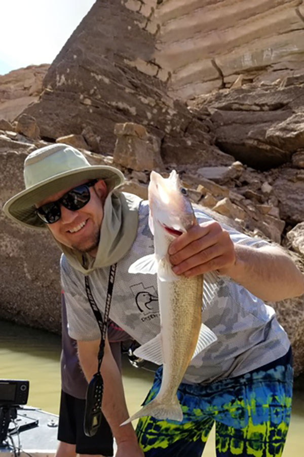Dan Keller at Lake Powell, holding a large, caught fish
