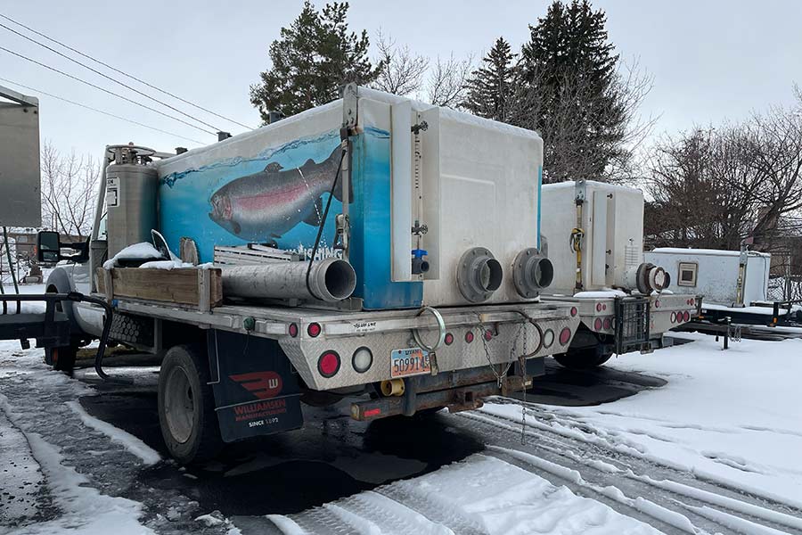 Fish hatchery trucks parked in a snow-covered lot