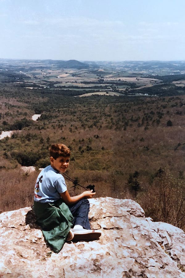 Billy Fenimore as a child on the Hawk Mountain trail in Pennsylvania, overlooking a wide valley