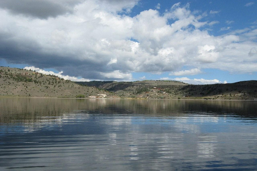 View of clear water at Panguitch Lake in southern Utah, amid cloudy skies
