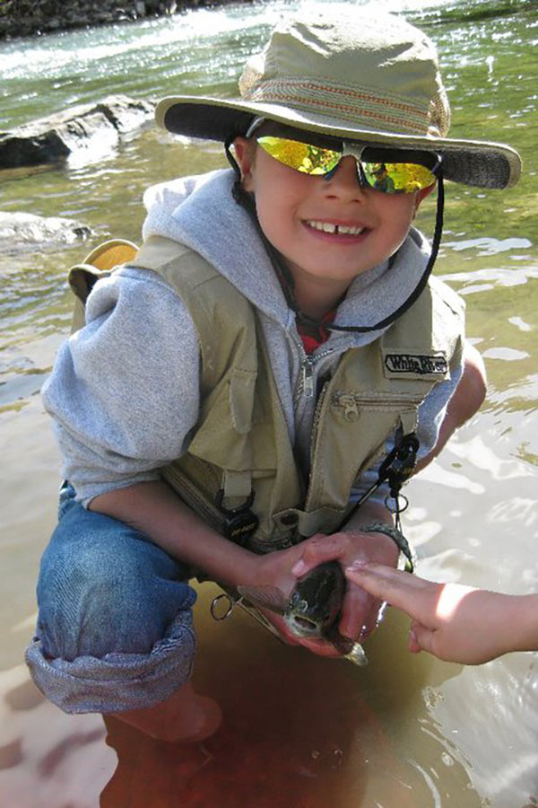 Boy holding a fish caught in the Lower Provo River