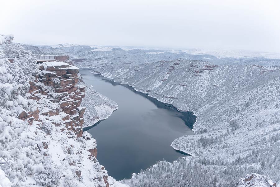 View of Flaming Gorge Reservoir in the winter, with the cliffs blanketed by snow