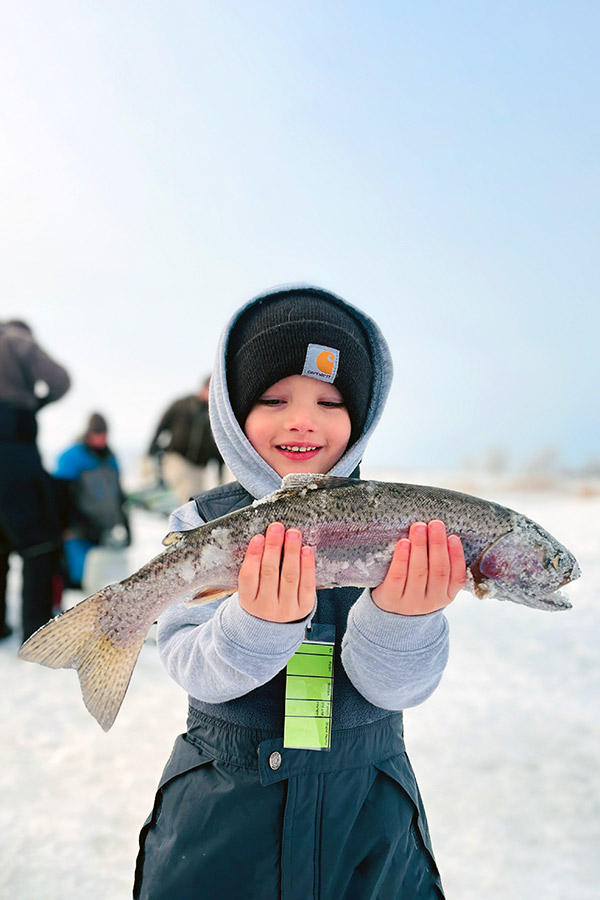 Boy holding a trout fish caught at Steinaker Reservoir