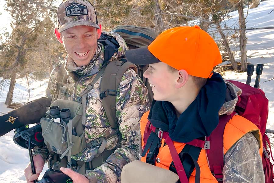 A father and son hunt big game in the forest