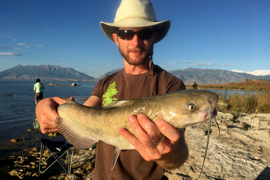 Chris Crockett holding a catfish caught at Utah Lake