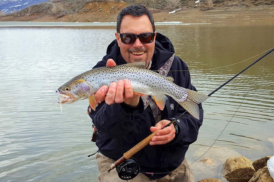 Angler holding a Bonneville cutthroat trout caught at Lost Creek Reservoir