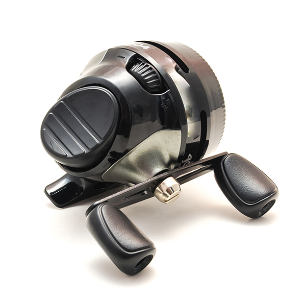 Spincast fishing reel, showing case and button