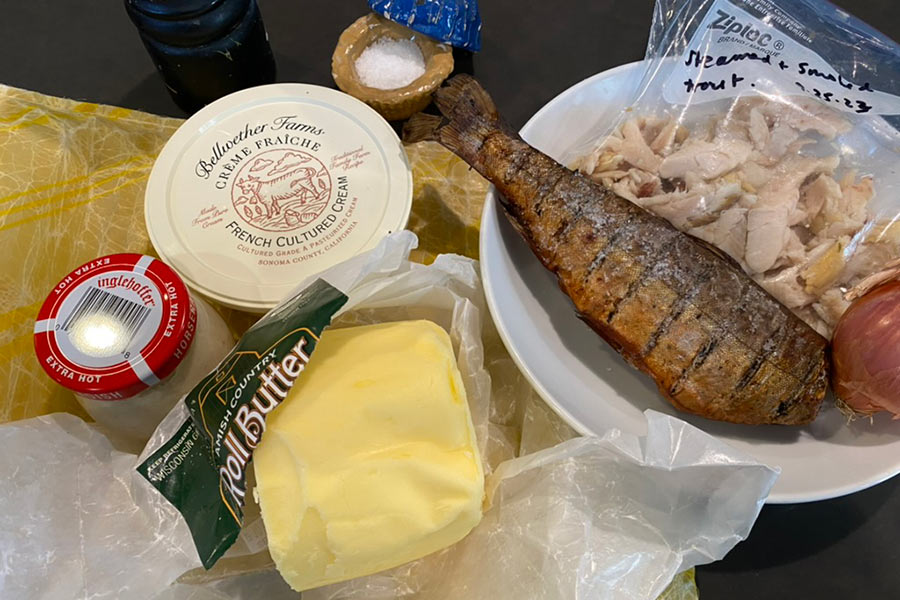 Ingredients for smoked trout rillettes, inclunding a smoked trout, butter and horseradish