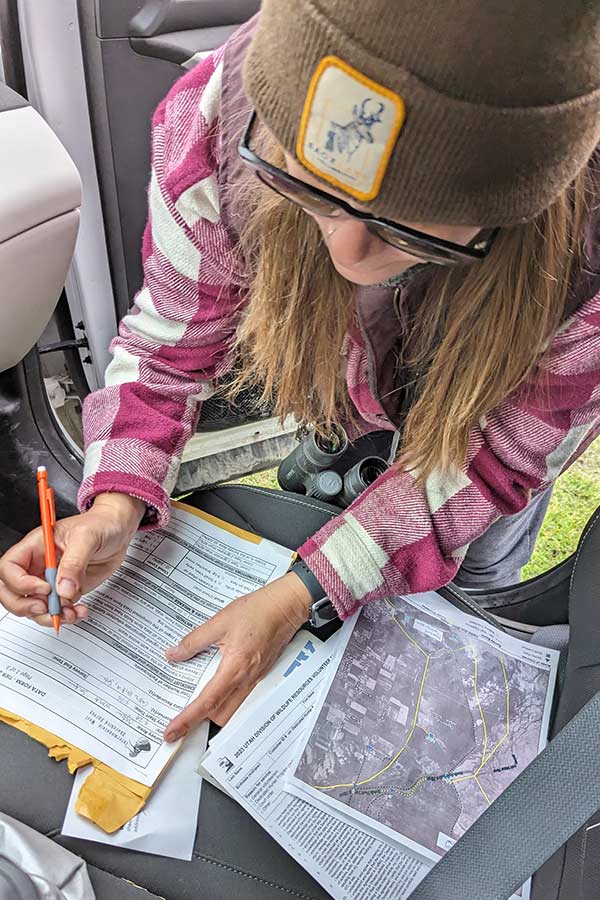 Intermountain West Shorebird Survey researcher compiling data from observations at Ogden Bay