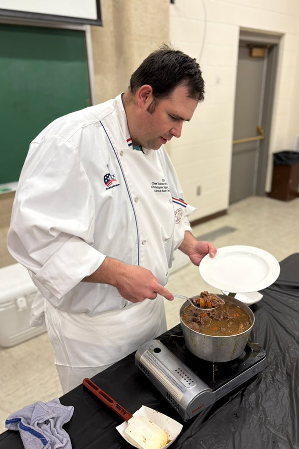 Chef Chris Taggart dishing up a plate of pheasant coq au vin