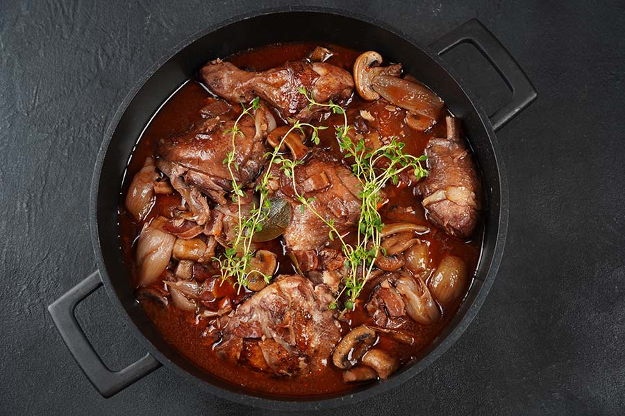 Pheasant coq au vin in a pot on a countertop
