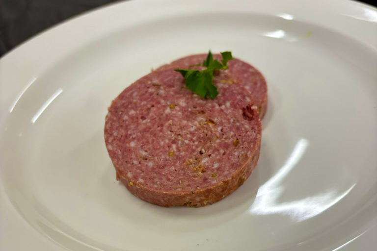 Elk summer sausage, prepared by Chef Chris Taggart, on a plate