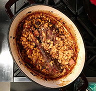 Wild turkey cassoulet in a Dutch oven on a stove