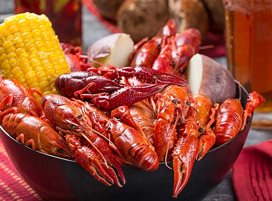 Boiled crayfish in a bowl with corn