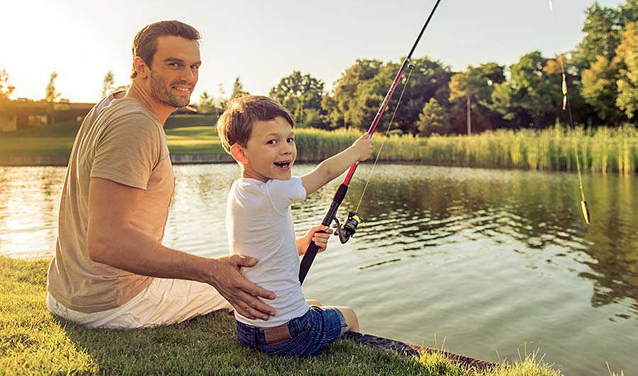 Father and son fishing at a pond