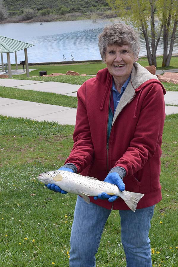 Woman holding a fish she caught at East Canyon State Park