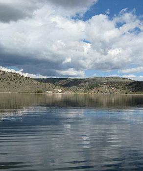 View of clear water at Panguitch Lake in southern Utah, amid cloudy skies
