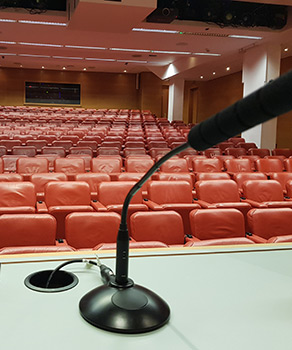 Microphone at a podium in front of an empty auditorium