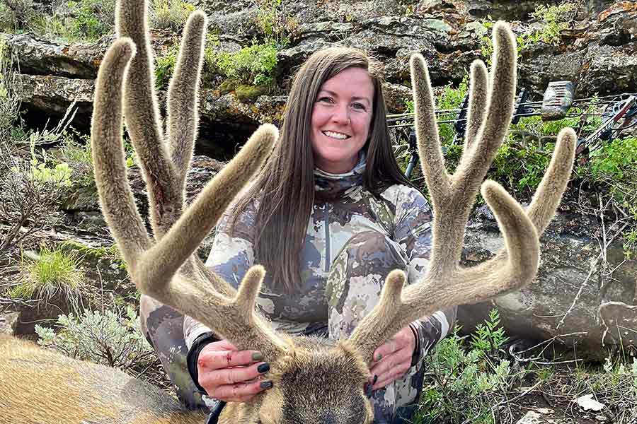Heidi Heckethorn holding a harvested buck deer