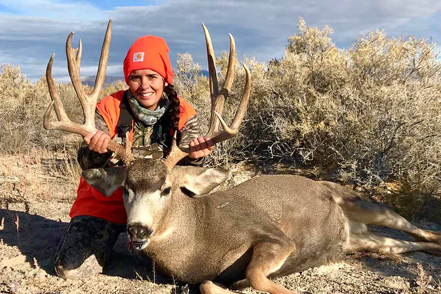 Lokelani Ferre posing with a harvested buck deer