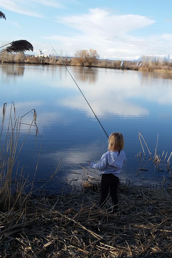 Child fishing at pond