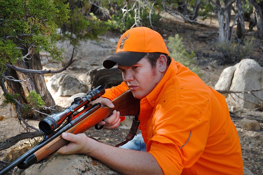 Youth hunter with rifle