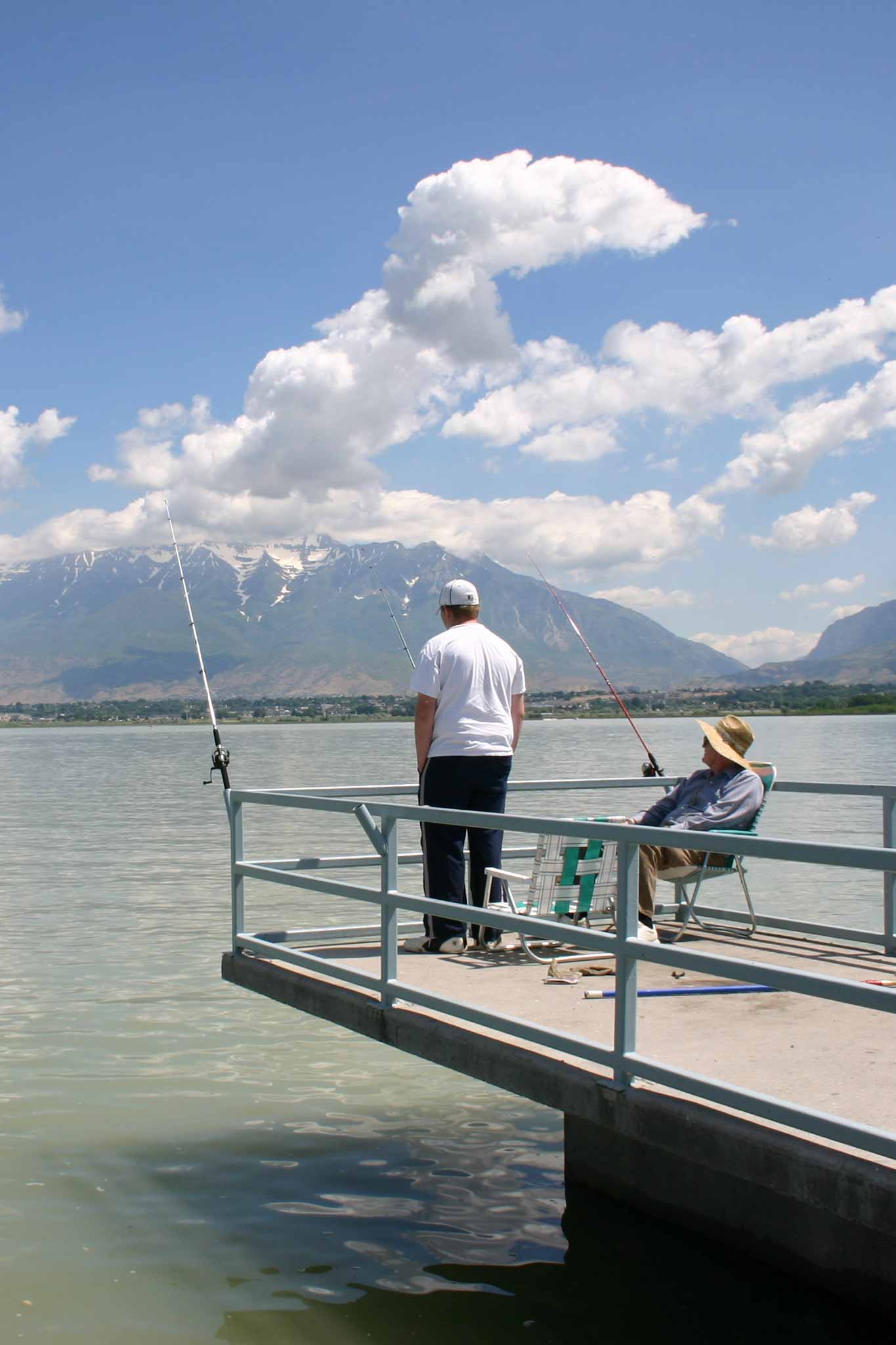 Two anglers fishing from a pier at Utah Lake