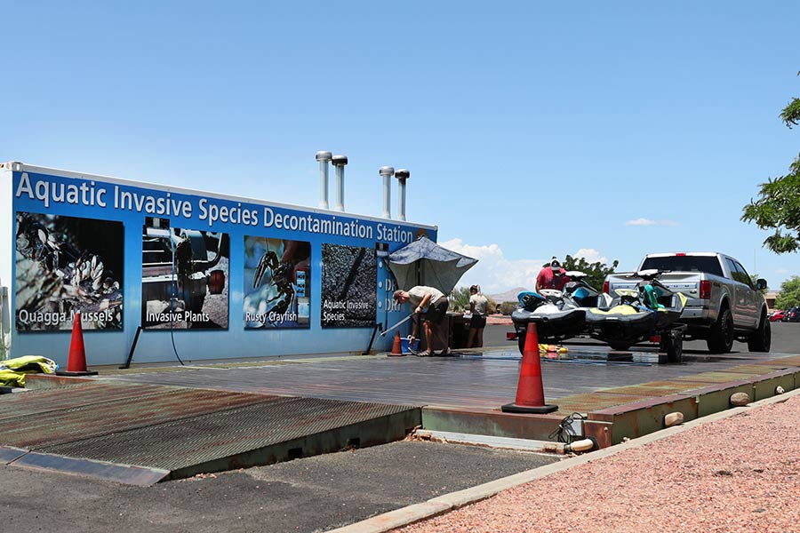 Aquatic Invasive Species decontamination station with a truck and two small watercraft