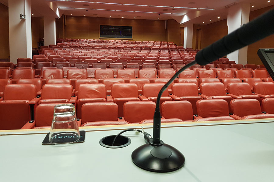 Empty auditorium with microphone on a table